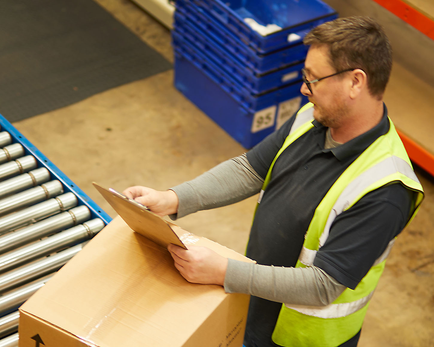 Worker checking and packing orders